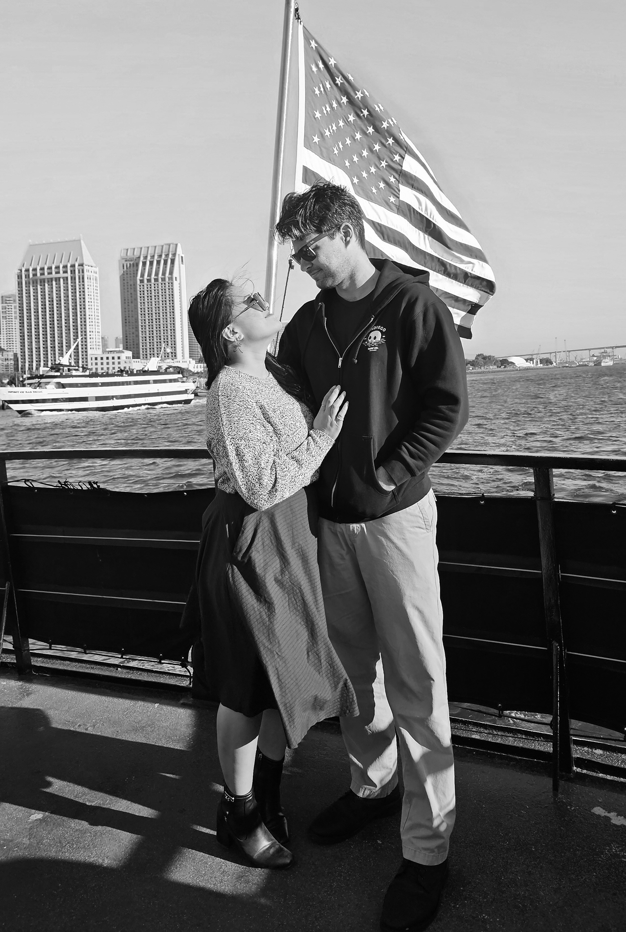 Taryn and Nathan at the harbor with an American flag
